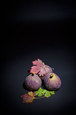 Figs on a black surface and black backgroundの写真素材