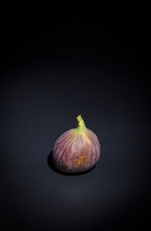 Figs on a black surface and black backgroundの写真素材