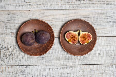 Ripe figs on a white wooden surfaceの写真素材