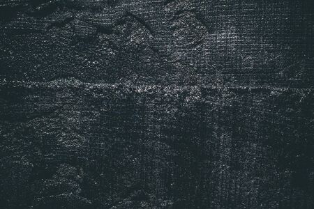 Black resin wall texture with scratches and cracks.の写真素材