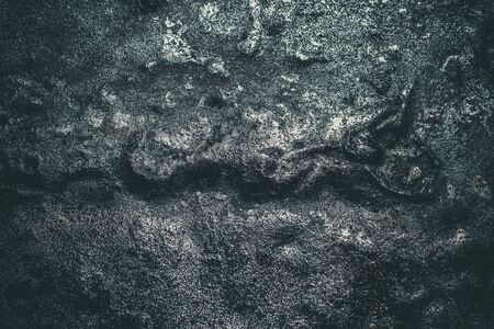 Black resin wall texture with scratches and cracks.の写真素材