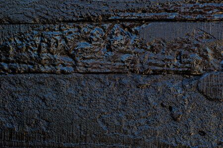 Black resin wall texture with scratches and cracks.の写真素材