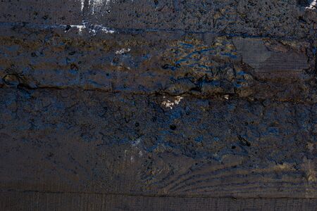 Black resin wall texture with scratches and cracks.の写真素材