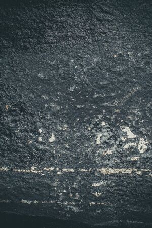 Black resin wall texture with scratches and cracks.の写真素材