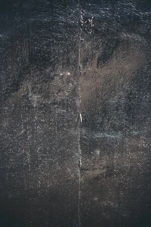 Black resin wall texture with scratches and cracks.の写真素材