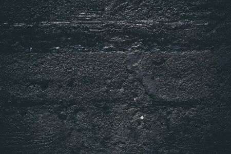 Black resin wall texture with scratches and cracks.の写真素材