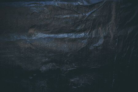 Black resin wall texture with scratches and cracks.の写真素材