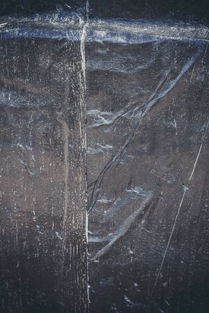 Black resin wall texture with scratches and cracks.の写真素材