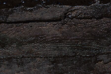 Black resin wall texture with scratches and cracks.の写真素材