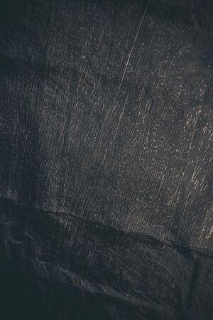 Black resin wall texture with scratches and cracks.の写真素材