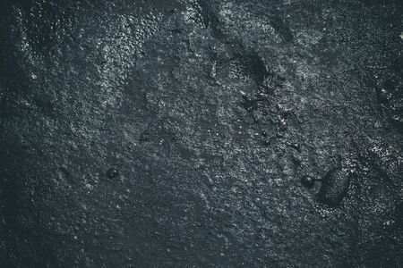 Black resin wall texture with scratches and cracks.