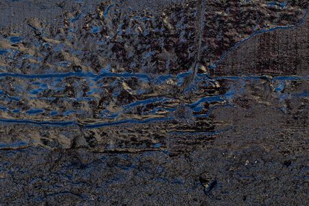 Black resin wall texture with scratches and cracks.の写真素材