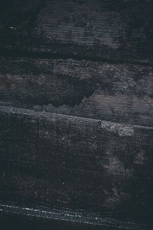 Black resin wall texture with scratches and cracks.の写真素材