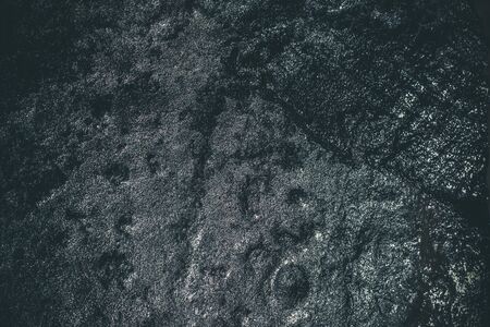 Black resin wall texture with scratches and cracks.の写真素材