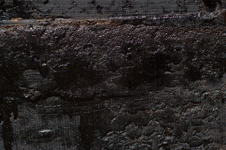 Black resin wall texture with scratches and cracks.の写真素材
