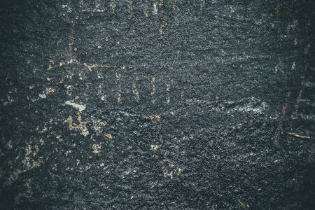 Black resin wall texture with scratches and cracks.の写真素材