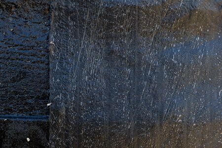 Black resin wall texture with scratches and cracks.の写真素材