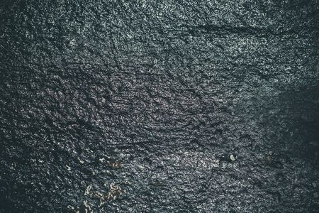 Black resin wall texture with scratches and cracks.の写真素材