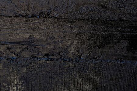 Black resin wall texture with scratches and cracks.の写真素材
