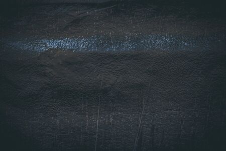 Black resin wall texture with scratches and cracks.の写真素材