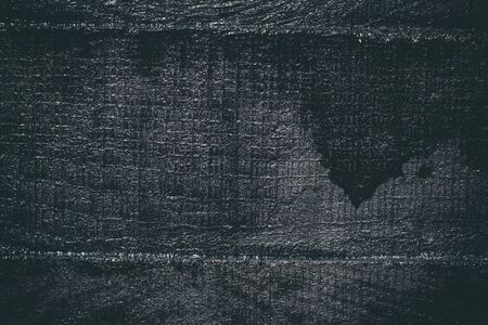 Black resin wall texture with scratches and cracks.の写真素材