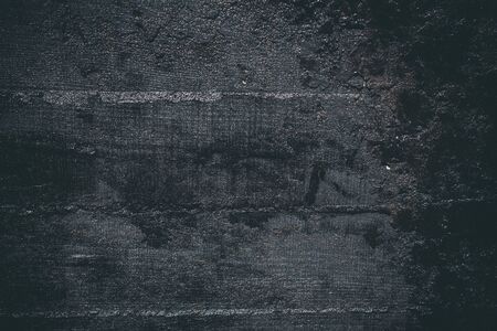 Black resin wall texture with scratches and cracks.の写真素材