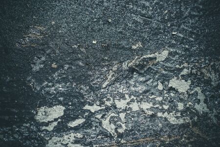 Black resin wall texture with scratches and cracks.の写真素材