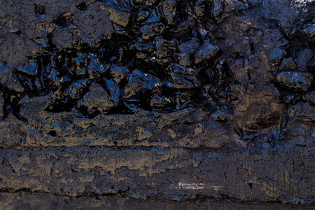 Black resin wall texture with scratches and cracks.の写真素材