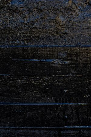 Black resin wall texture with scratches and cracks.の写真素材