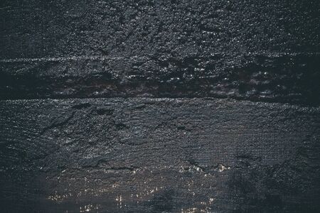 Black resin wall texture with scratches and cracks.の写真素材