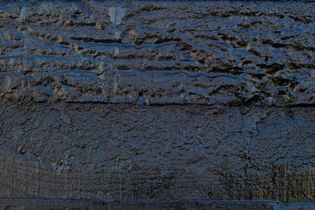 Black resin wall texture with scratches and cracks.の写真素材