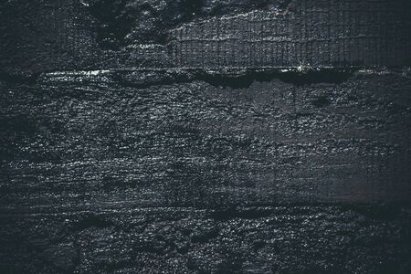 Black resin wall texture with scratches and cracks.の写真素材