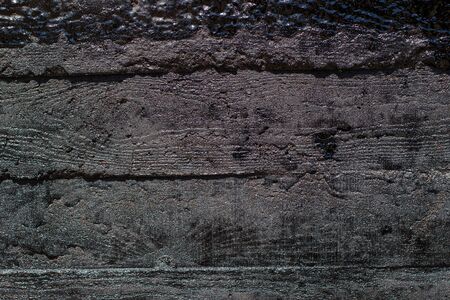Black resin wall texture with scratches and cracks.の写真素材