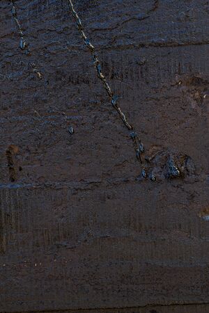 Black resin wall texture with scratches and cracks.の写真素材