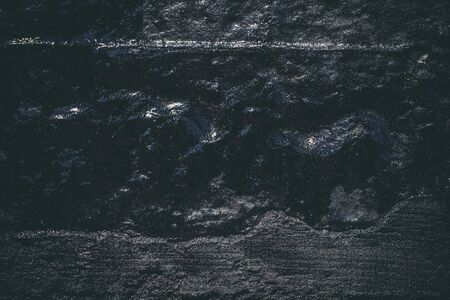 Black resin wall texture with scratches and cracks.の写真素材