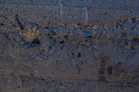 Black resin wall texture with scratches and cracks.の写真素材