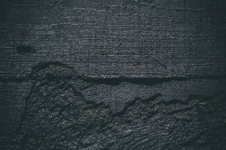 Black resin wall texture with scratches and cracks.の写真素材