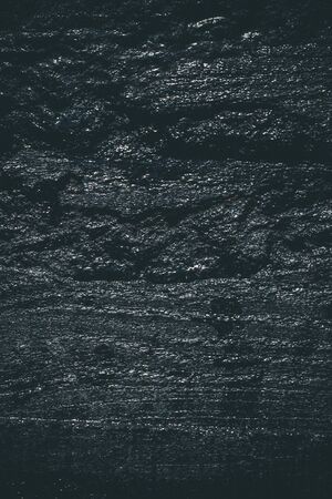 Black resin wall texture with scratches and cracks.の写真素材