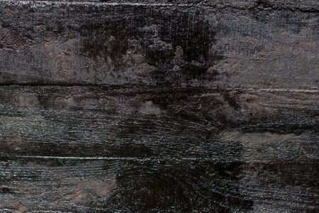 Black resin wall texture with scratches and cracks.の写真素材