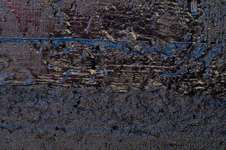 Black resin wall texture with scratches and cracks.の写真素材
