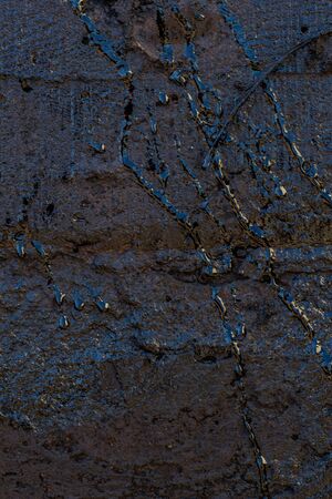 Black resin wall texture with scratches and cracks.の写真素材