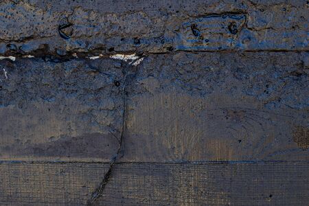 Black resin wall texture with scratches and cracks.の写真素材