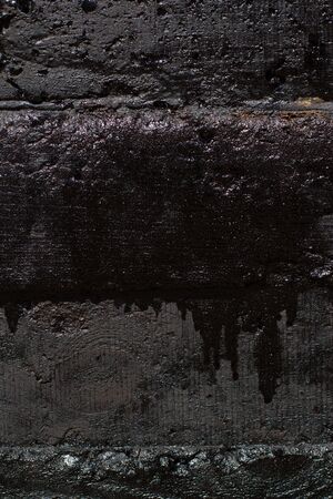 Black resin wall texture with scratches and cracks.の写真素材