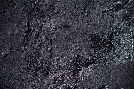 Black resin wall texture with scratches and cracks.の写真素材