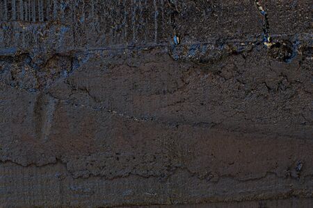 Black resin wall texture with scratches and cracks.の写真素材