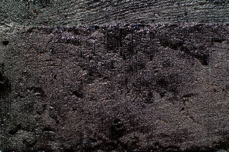 Black resin wall texture with scratches and cracks.の写真素材