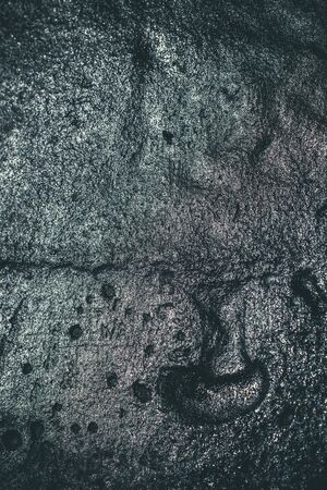 Black resin wall texture with scratches and cracks.の写真素材