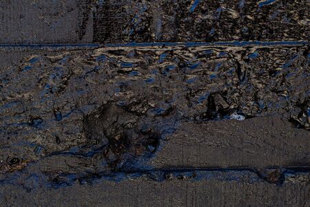 Black resin wall texture with scratches and cracks.の写真素材