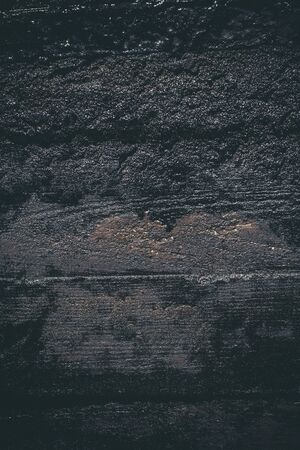Black resin wall texture with scratches and cracks.の写真素材