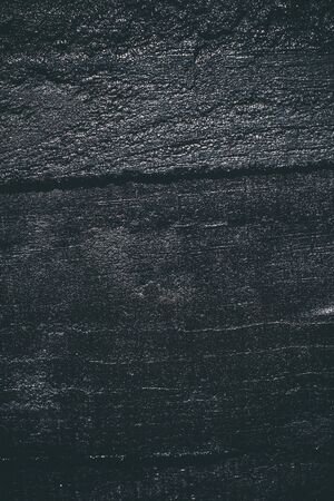 Black resin wall texture with scratches and cracks.の写真素材